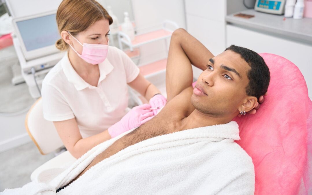 Male client receiving underarm laser hair removal in St. Petersburg, FL, with a licensed technician using diode laser technology.